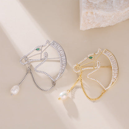 Gold and silver horse brooches side by side
