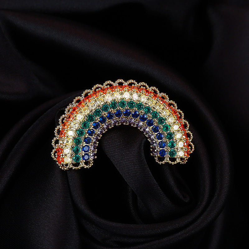 Rainbow zircon brooch catching the light