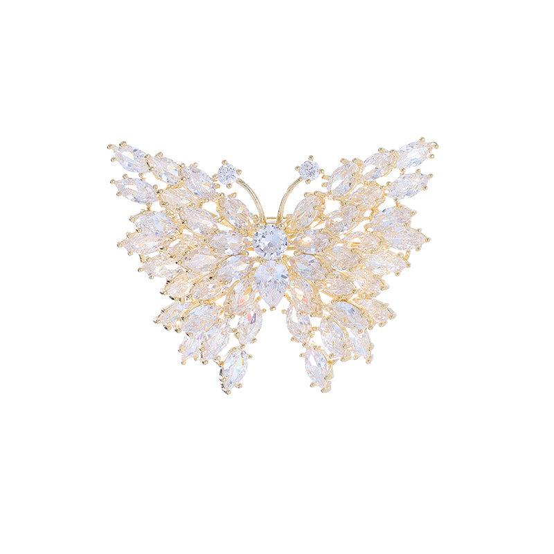 Gold butterfly brooch on white