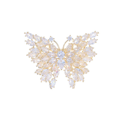 Gold butterfly brooch on white