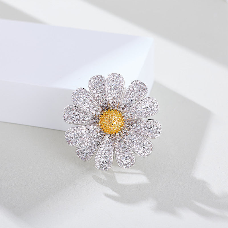 Zircon daisy brooch on white background