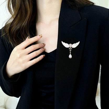 Angel wings brooch worn on a black blazer