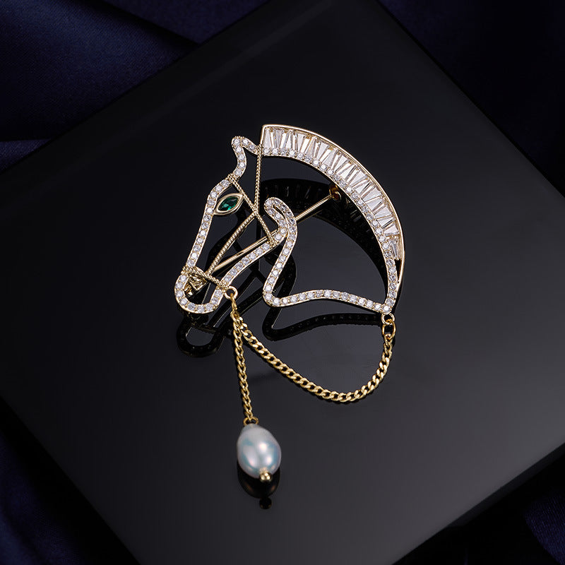Gold horse head brooch with zircon stones and freshwater pearl drop