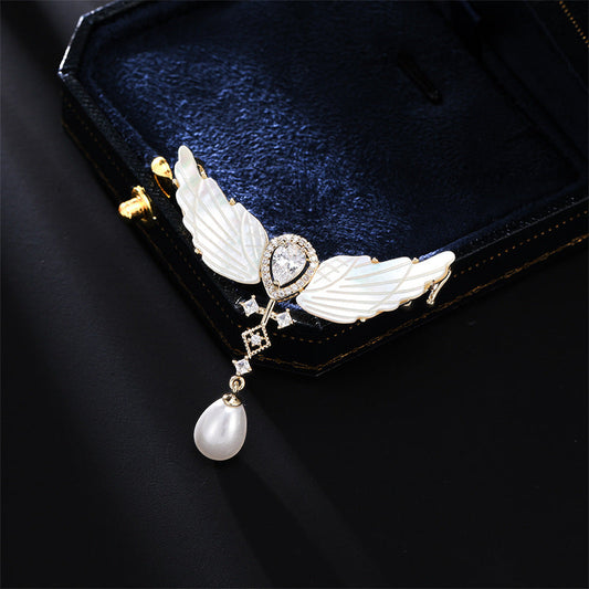 Angel wings brooch close-up with jewelry box