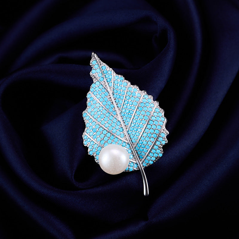 Turquoise leaf brooch with freshwater pearl on navy silk