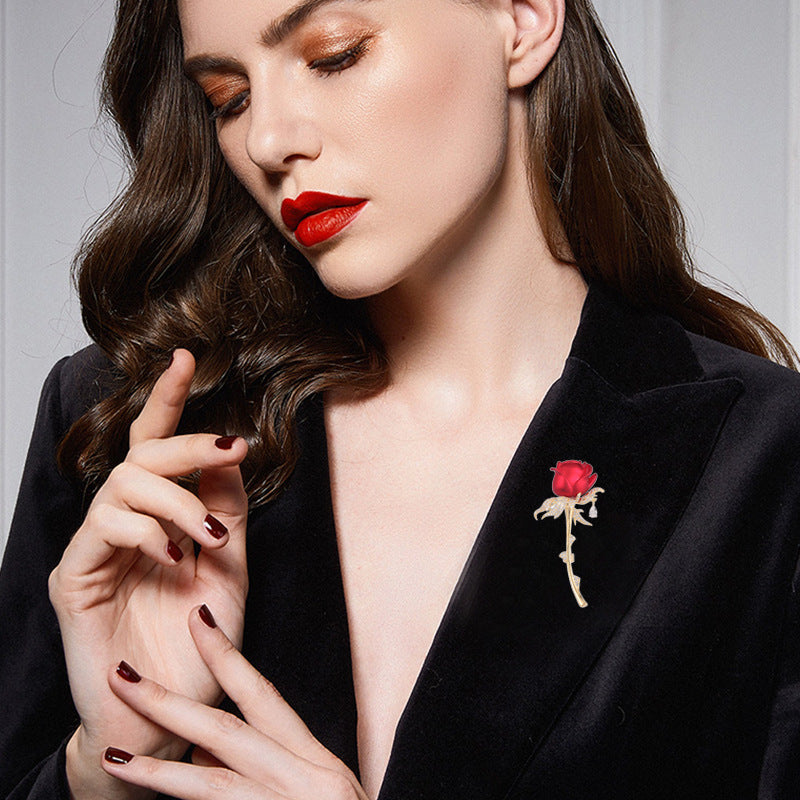 Close-up of model wearing the red rose brooch