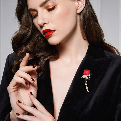 Close-up of model wearing the red rose brooch