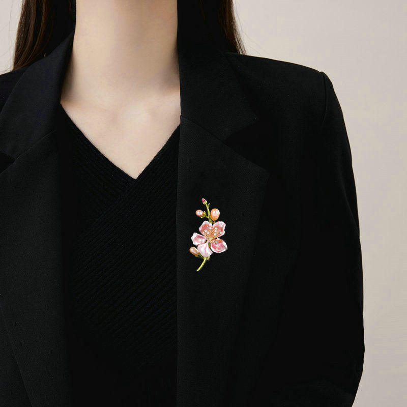 Magnolia brooch worn on a black blazer