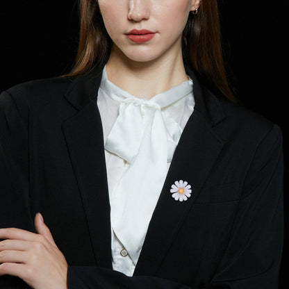Daisy brooch worn on a black blazer